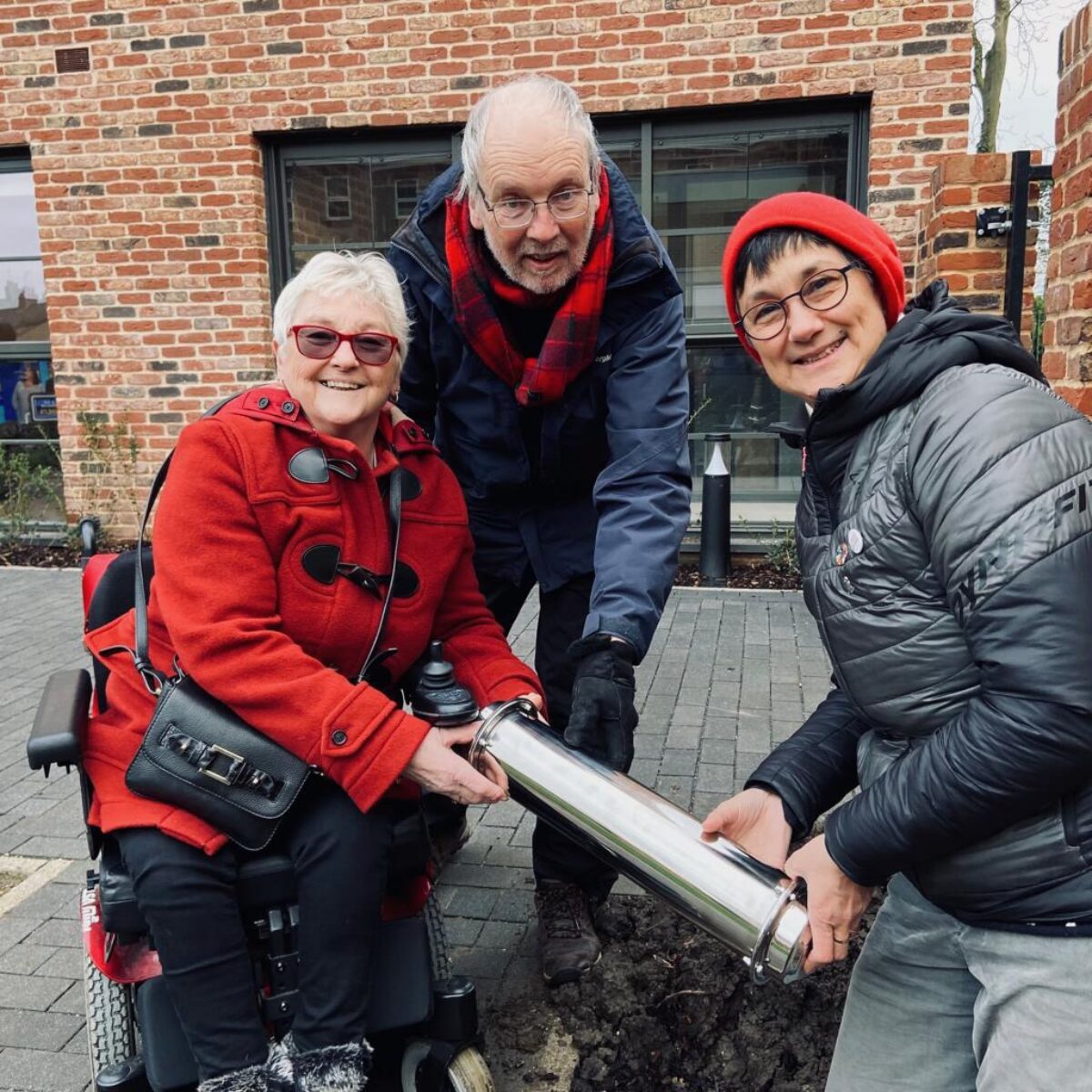 Cllrs Gerri Bird, Richard Robertson and Katie Thornburrow with a time capsule